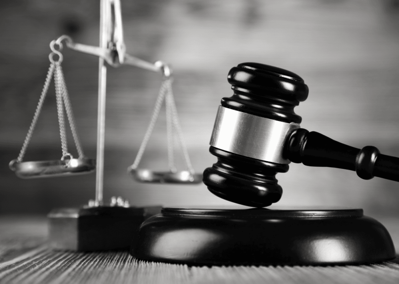 Judge’s gavel and scales on desk.