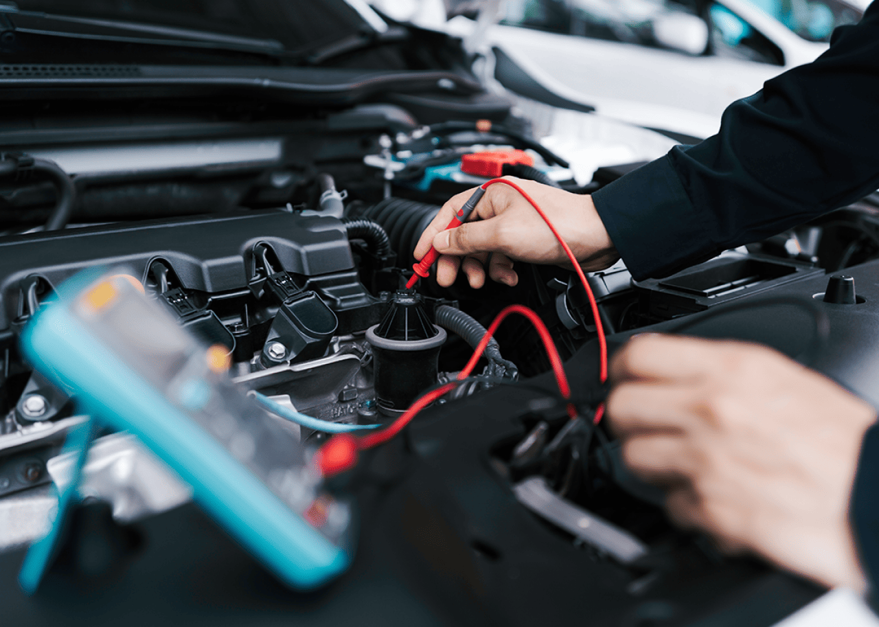 A mechanic inspecting a car battery.