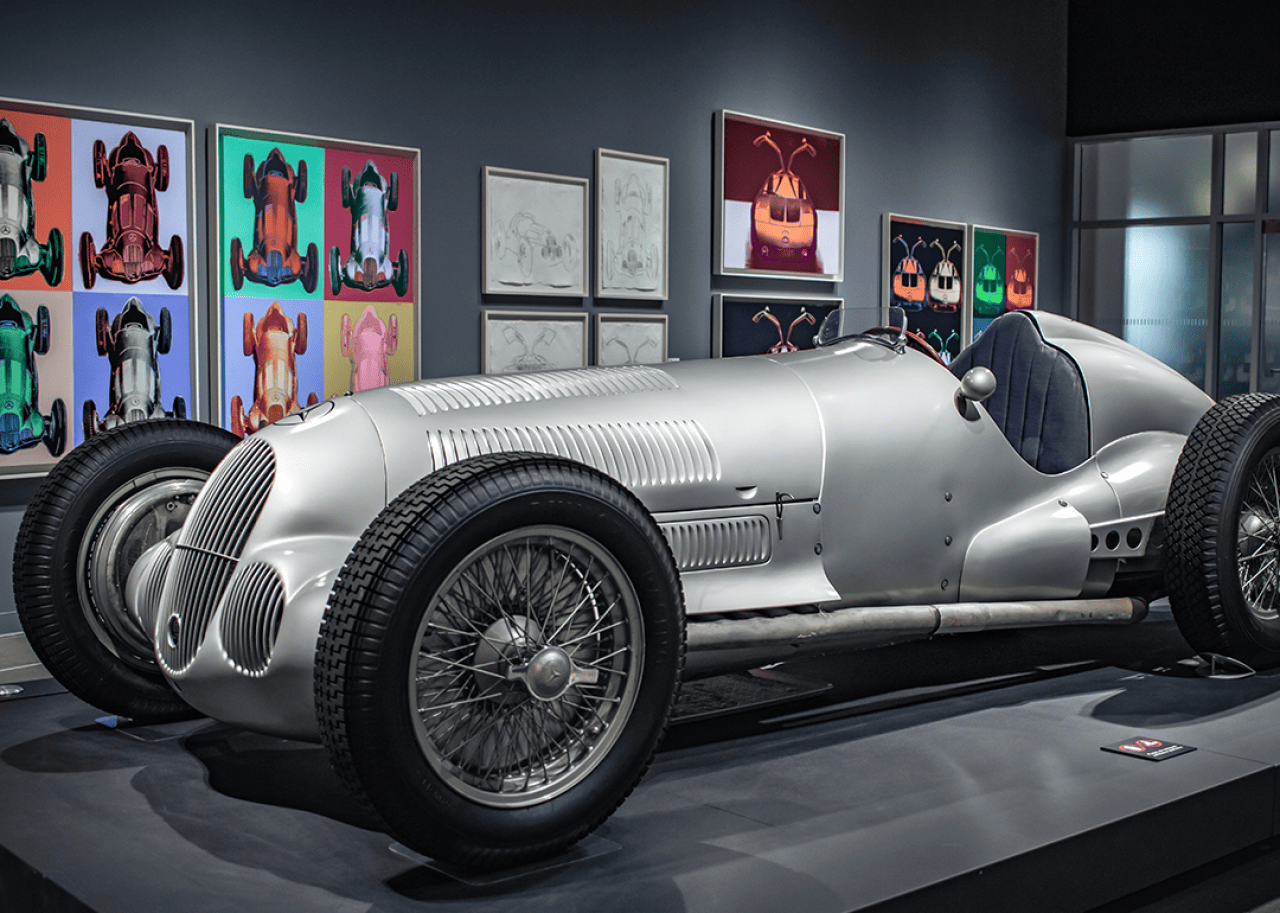 Silver Mercedes Benz on display inside.