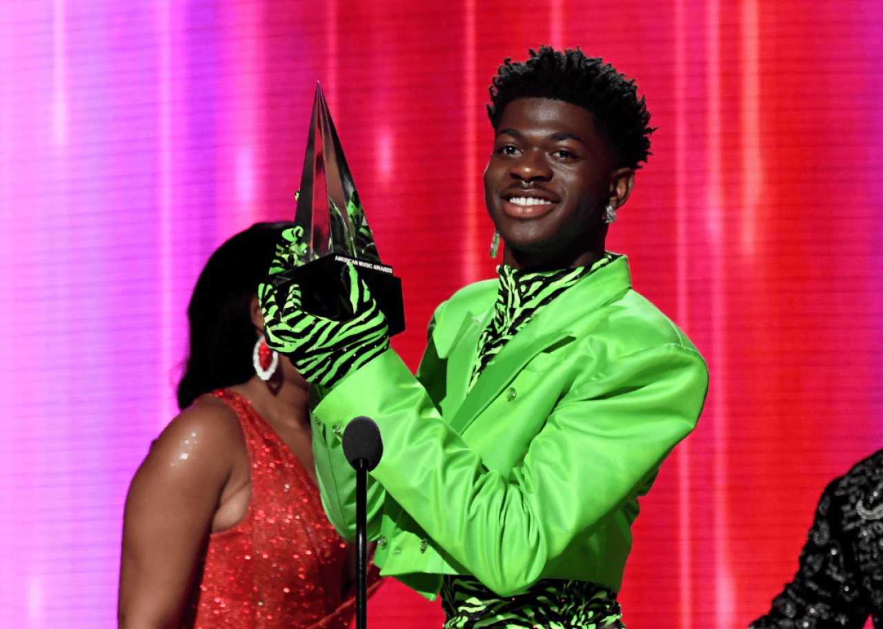 Lil Nas X: Longest-running #1 hit in Billboard Hot 100 history Lil Nas X accepts the American Music Award.