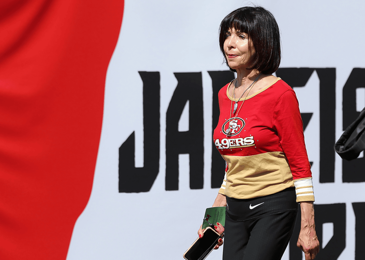 Denise DeBartolo York walks across the field at Raymond James Stadium in Tampa.