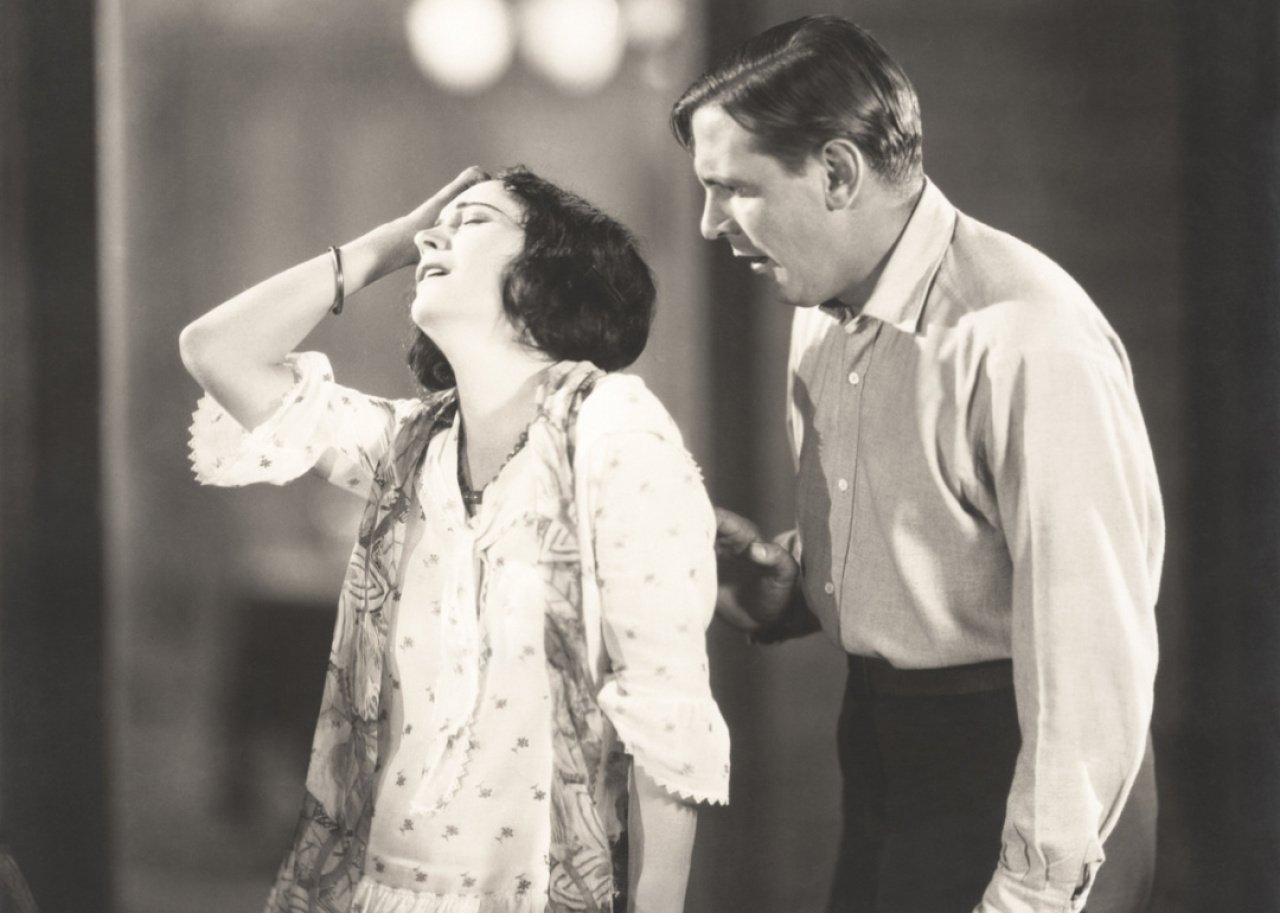 Vintage theatrical image woman with hand on head.