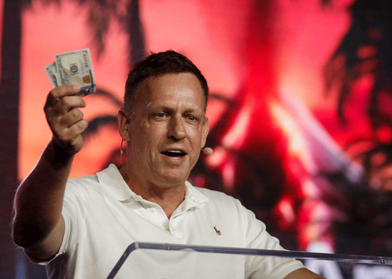 Peter Thiel Peter Thiel holding money as he speaks during the Bitcoin 2022 Conference.
