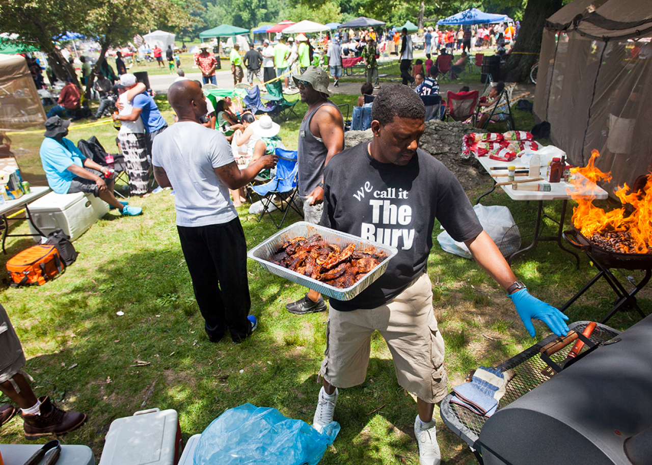 A man grills food at a Roxbury Juneteenth Celebration.