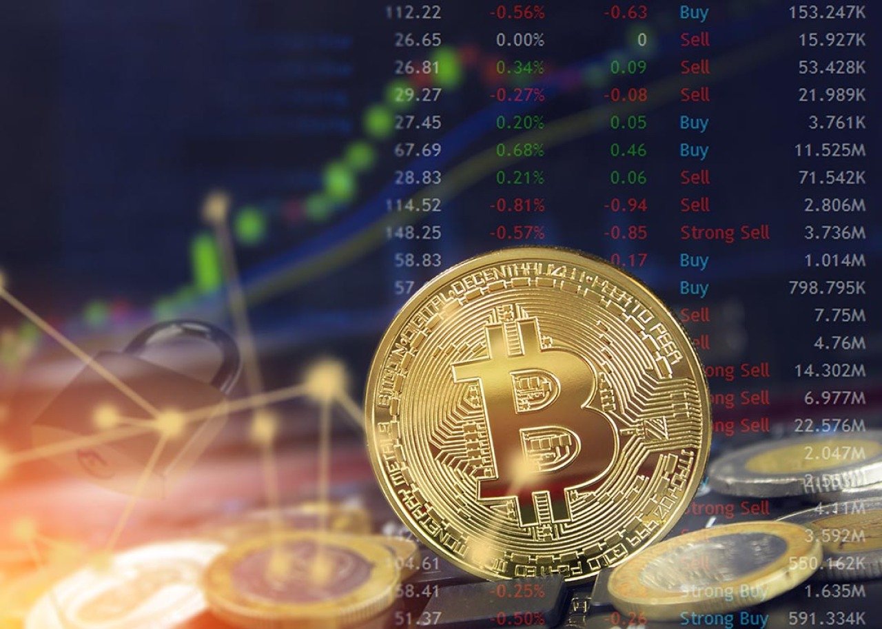 Bitcoin with stock market charts in background as concept of fluctuating cryptocurrrency values.