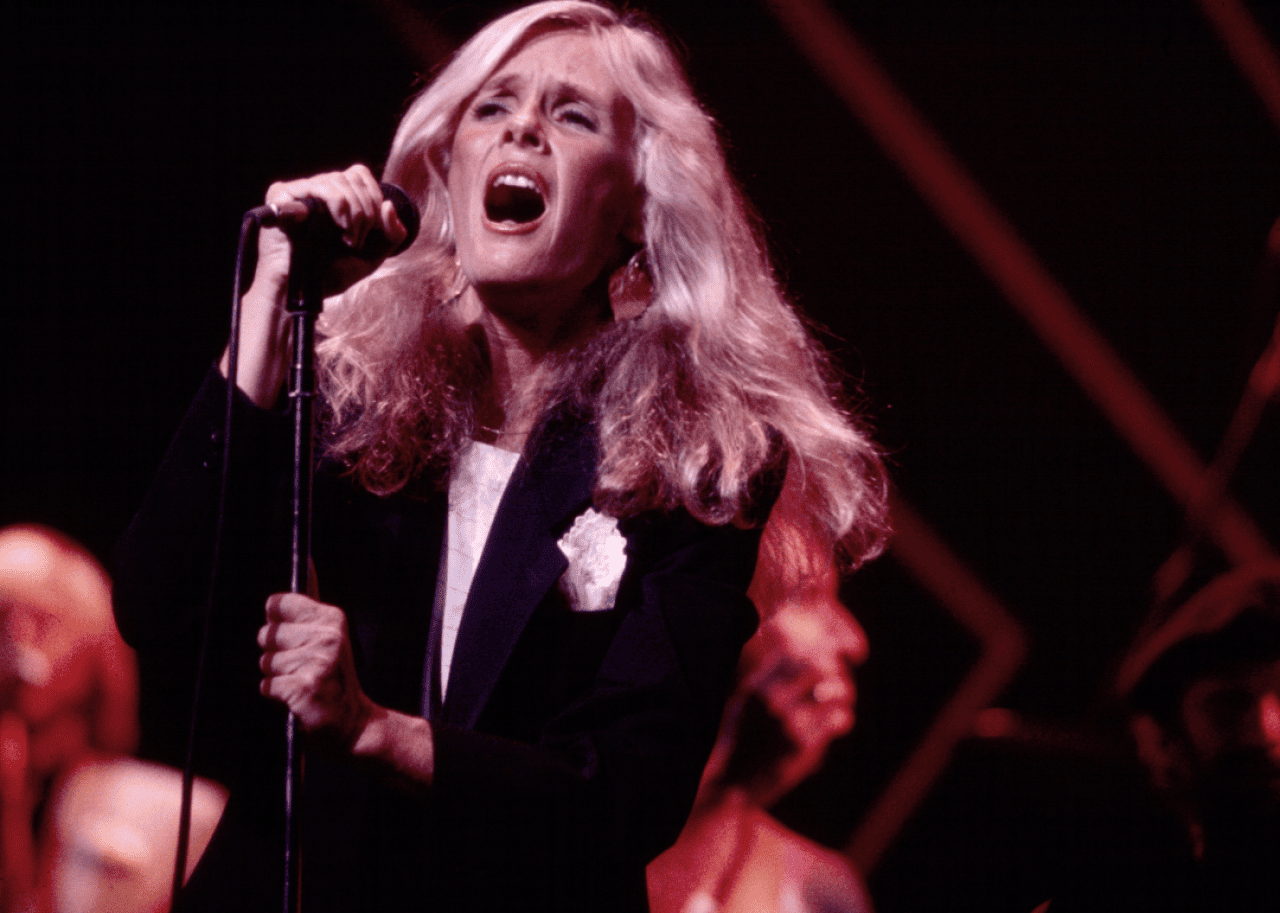American singer Kim Carnes performs, with her band, onstage at the Savoy, New York, New York, August 25, 1981.