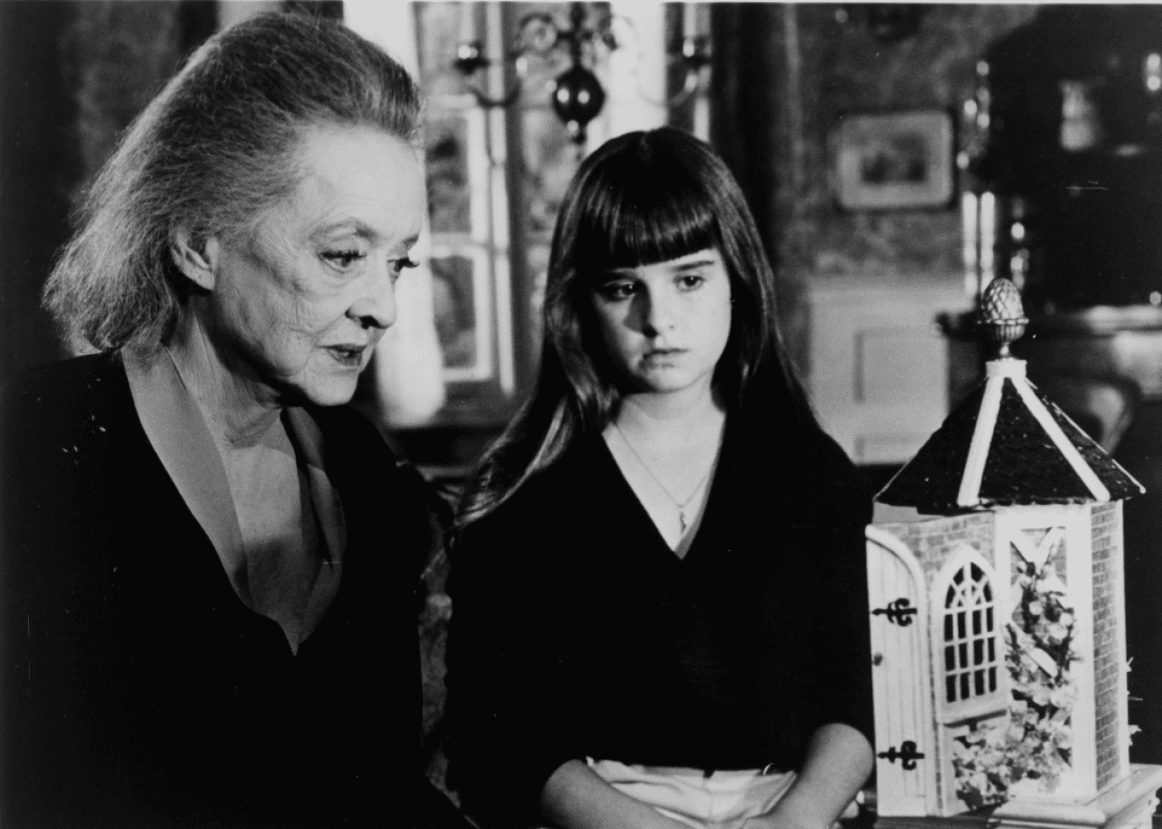 Bette Davis and Kyle Richards looks at a music box in a scene for the Walt Disney movie
