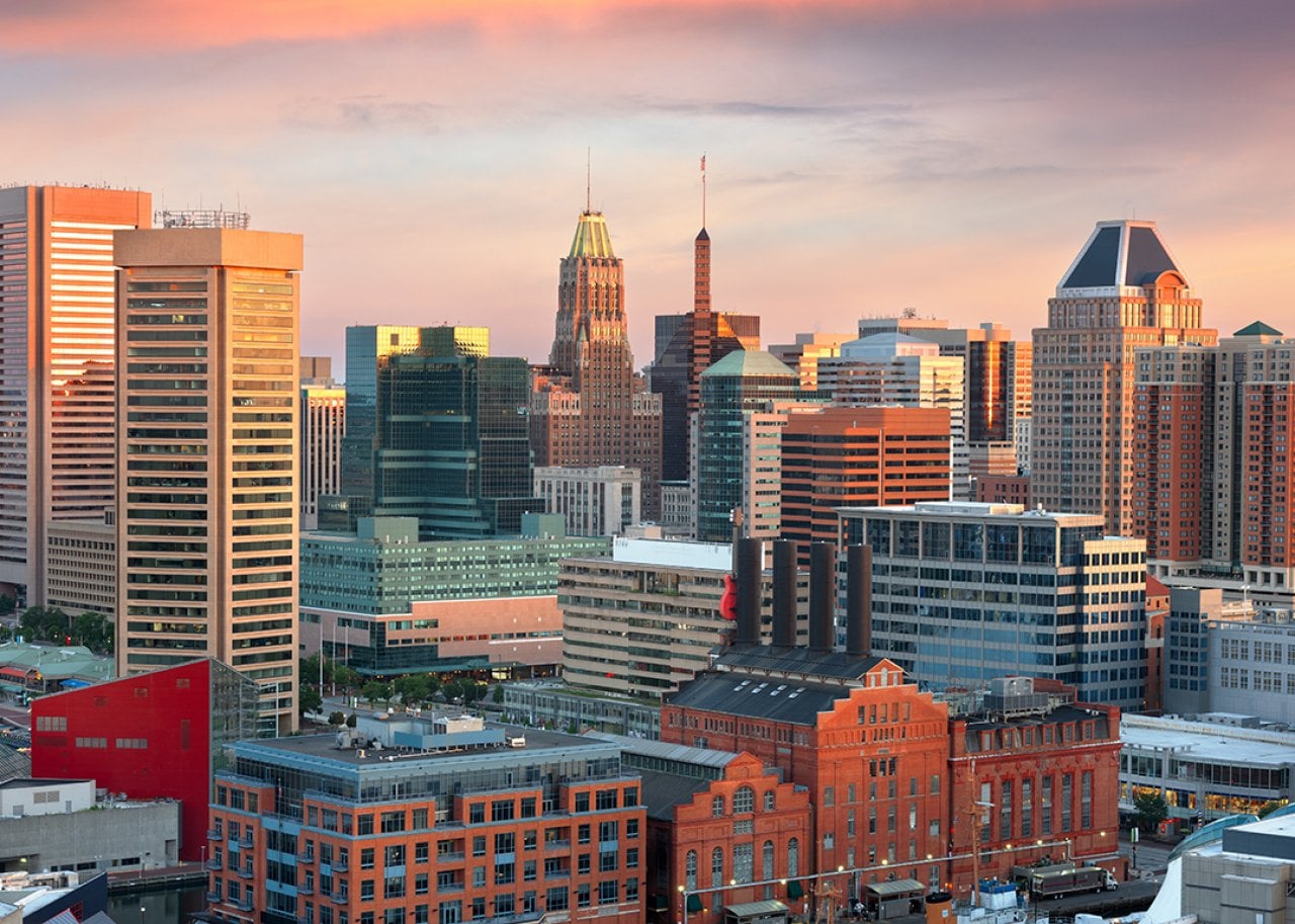 A view of the skyline during dawn over the Inner Harbor in Baltimore, Maryland.