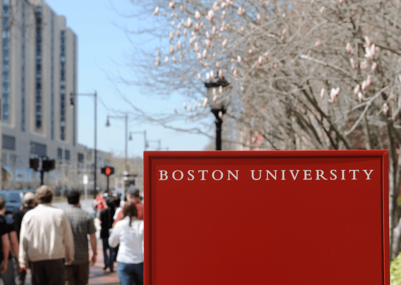 #15. Boston University Boston University campus sign with people walking in background.