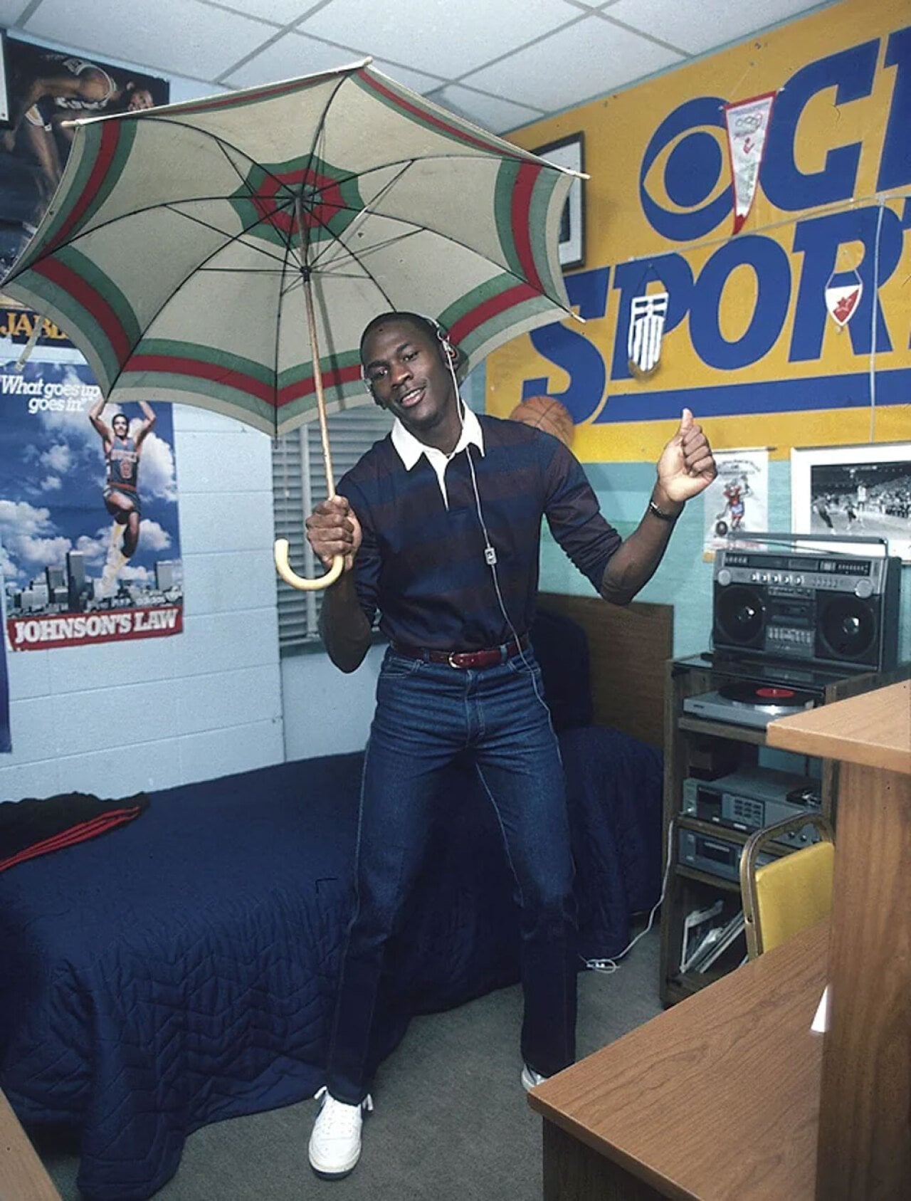 Michael Jordan holding an umbrella dancing in his dorm room