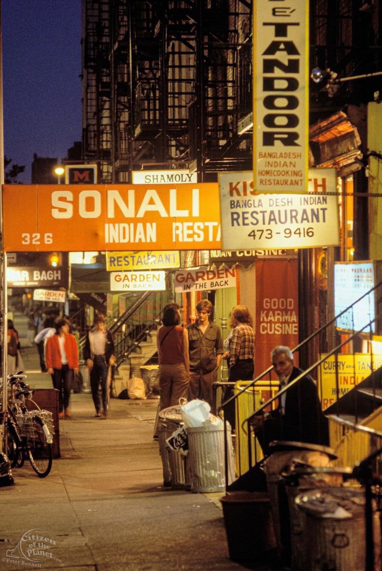 Some people sitting around on 6th street in NYC