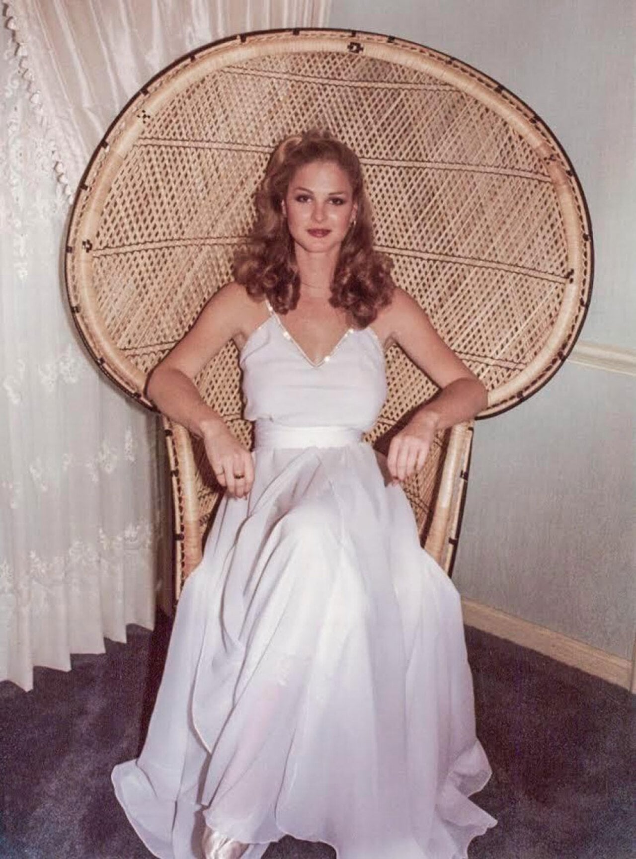 Woman in a wedding dress sitting in a chair