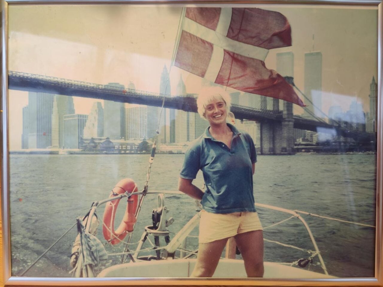 Woman smiling and proudly standing on her boy in the East River