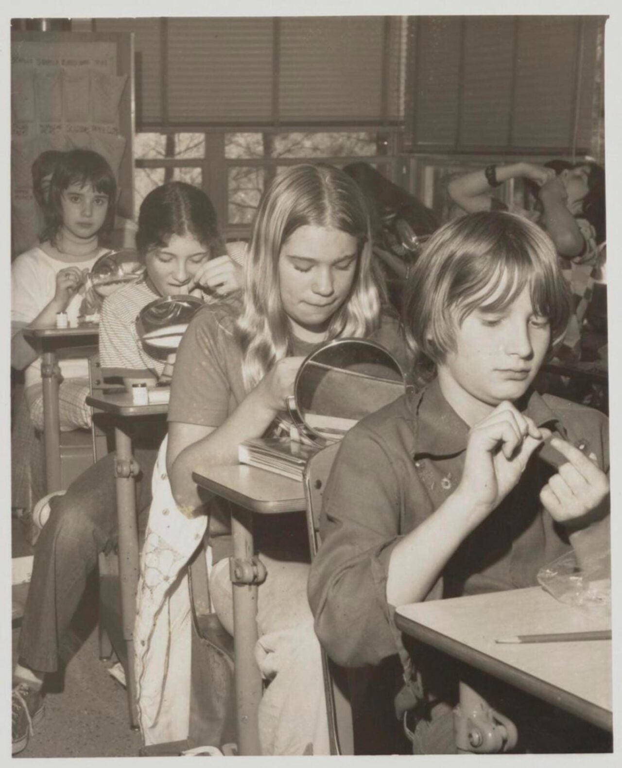 Black and white photo of students learning to floss