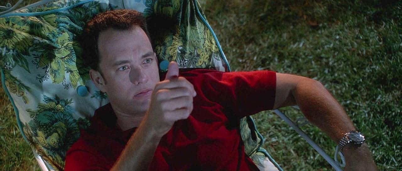 Tom Hanks wearing a red shirt for a scene of Apollo 13.