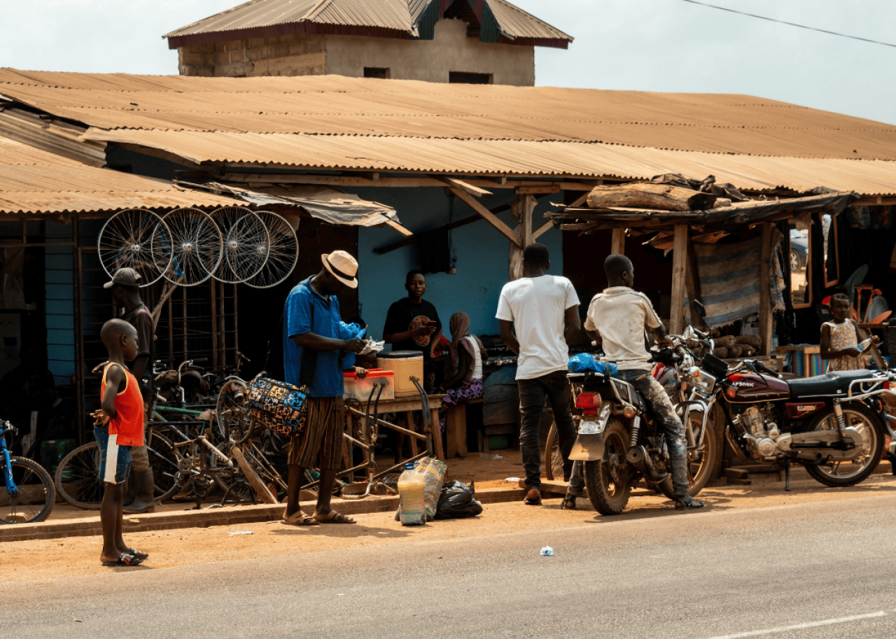 People standing in front of shops by roadside