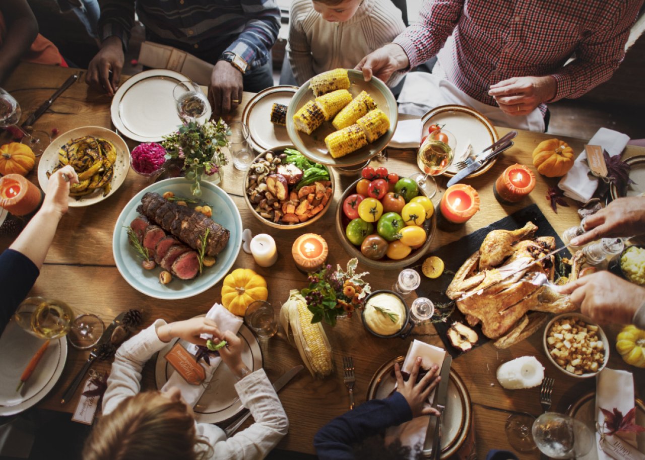 People seated around Thanksgiving table.