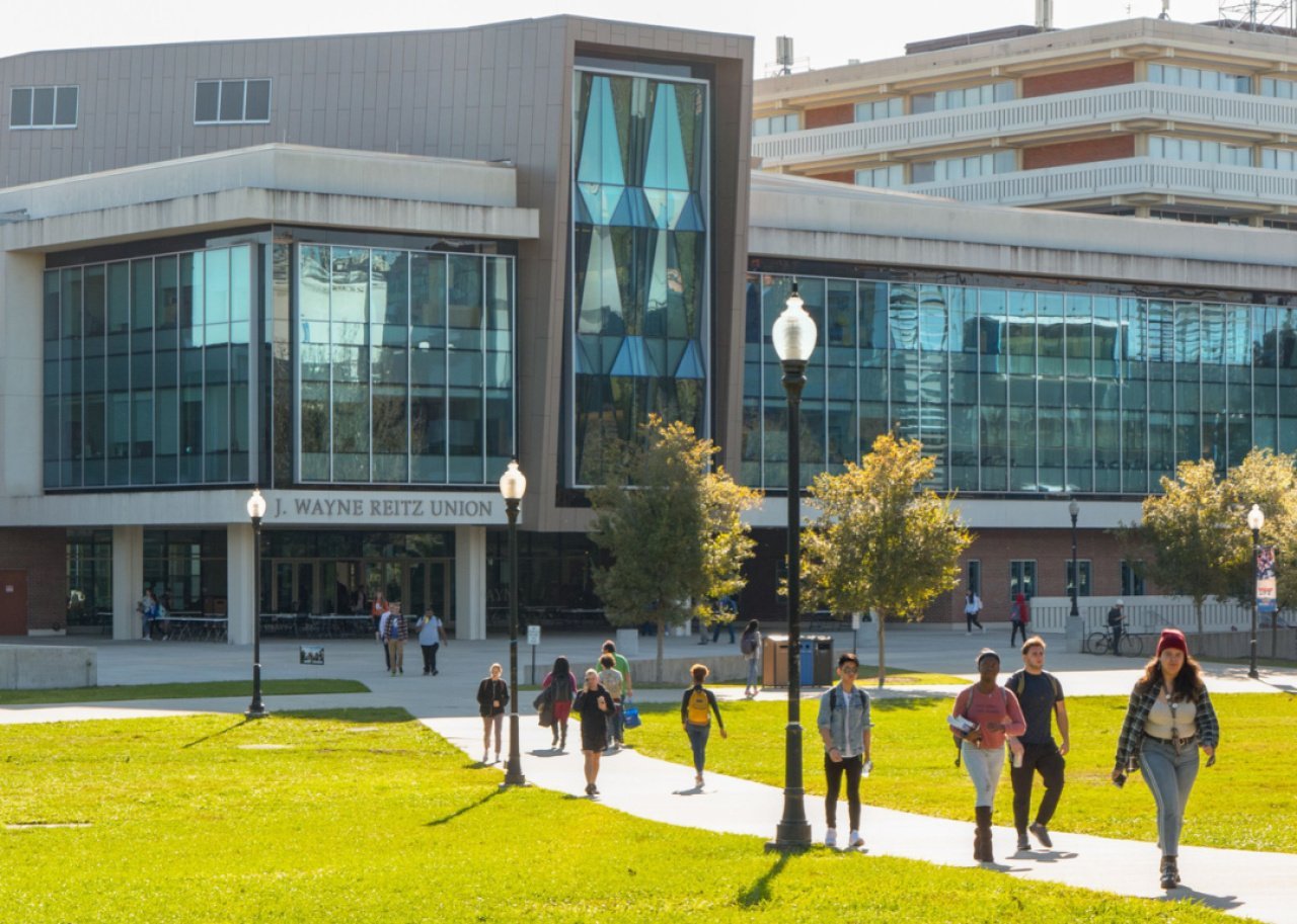 Students walk on the Quad lawn.