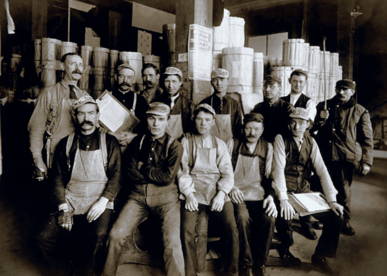 Group of men seated in warehouse