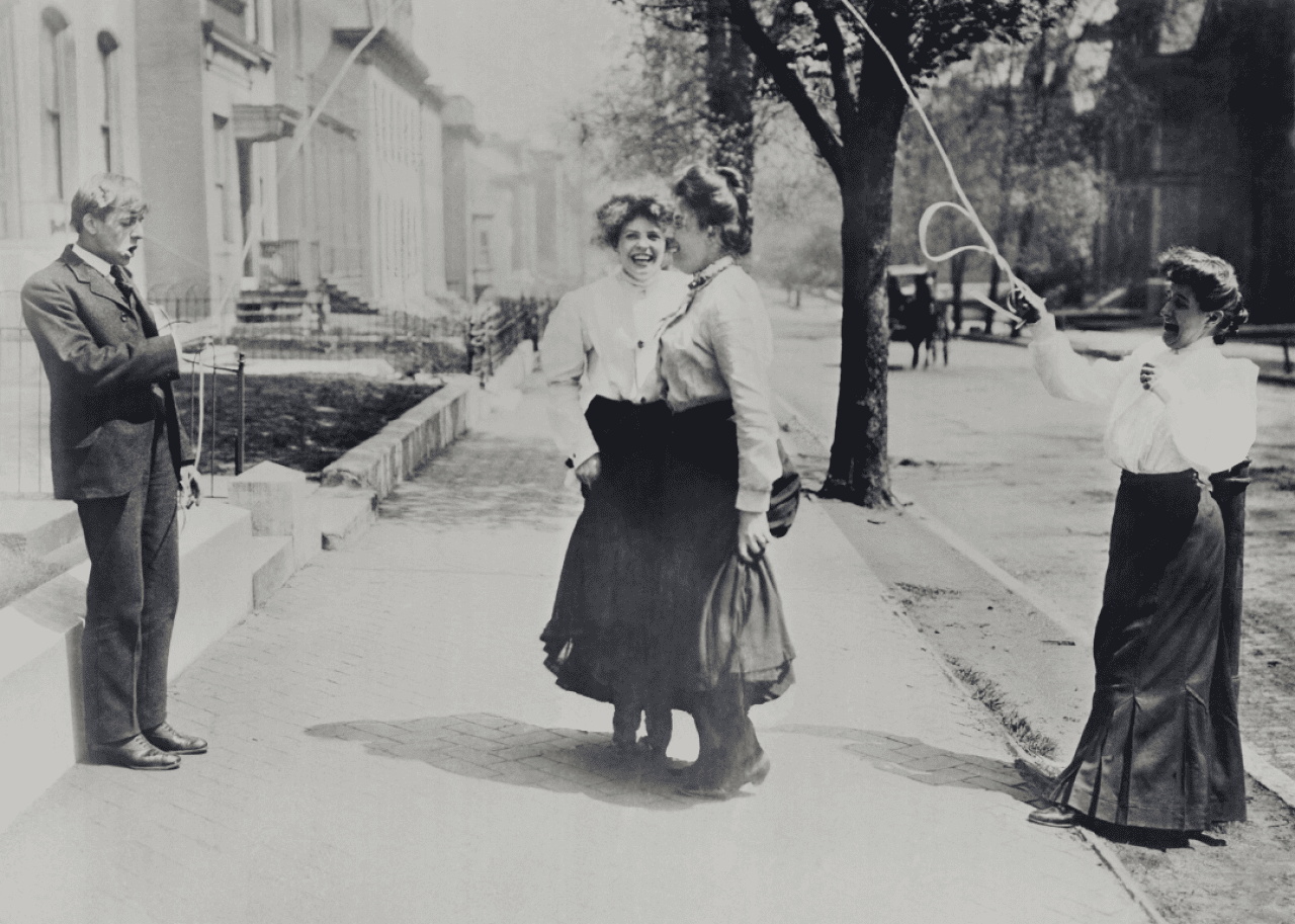 Adults jumping rope on sidewalk