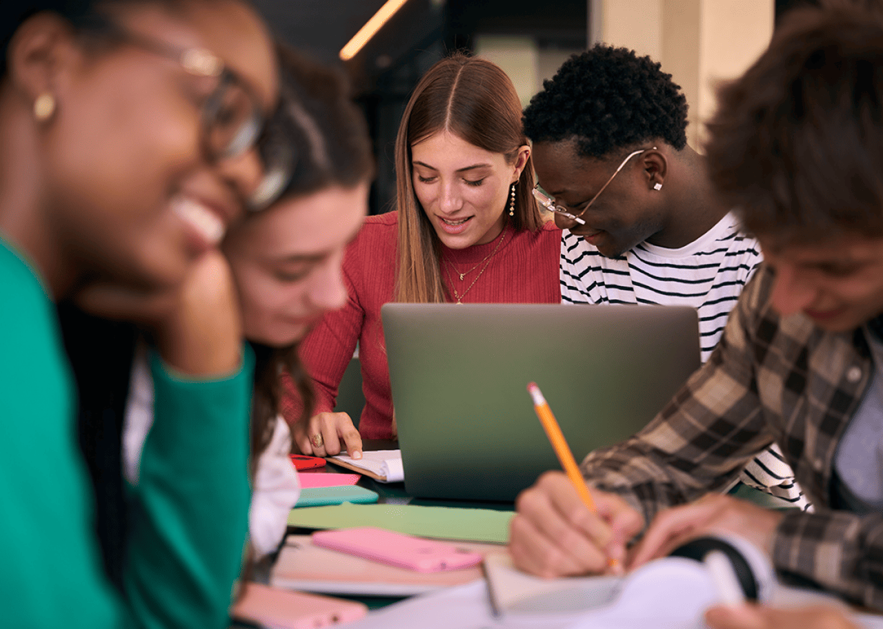 #41. Oklahoma City University Group of students working on a project together at table.