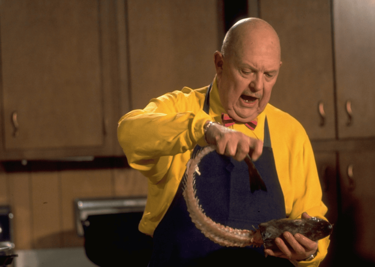 James Beard holding a fish head.