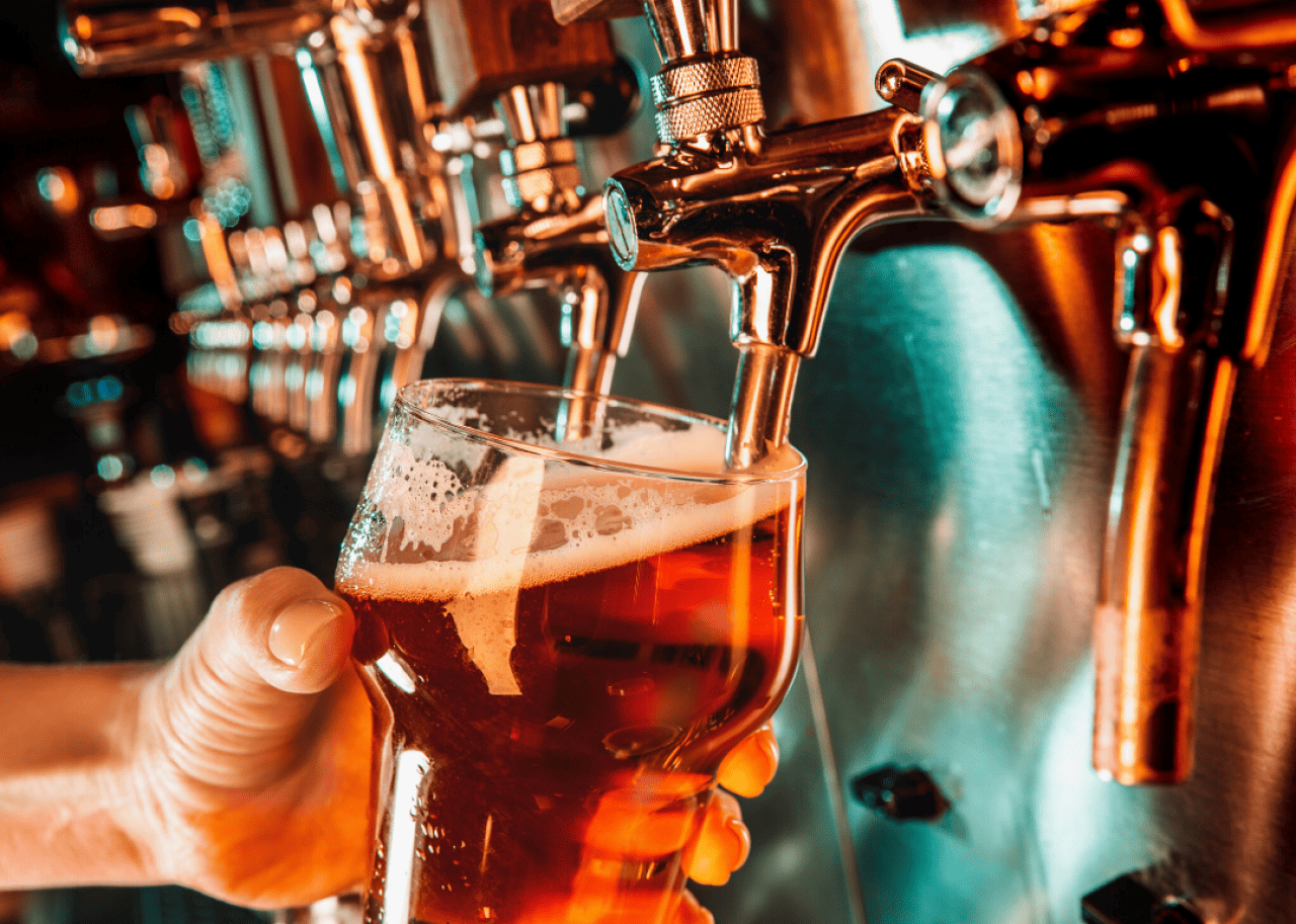 An amber-colored beer fills an imperial pint glass.