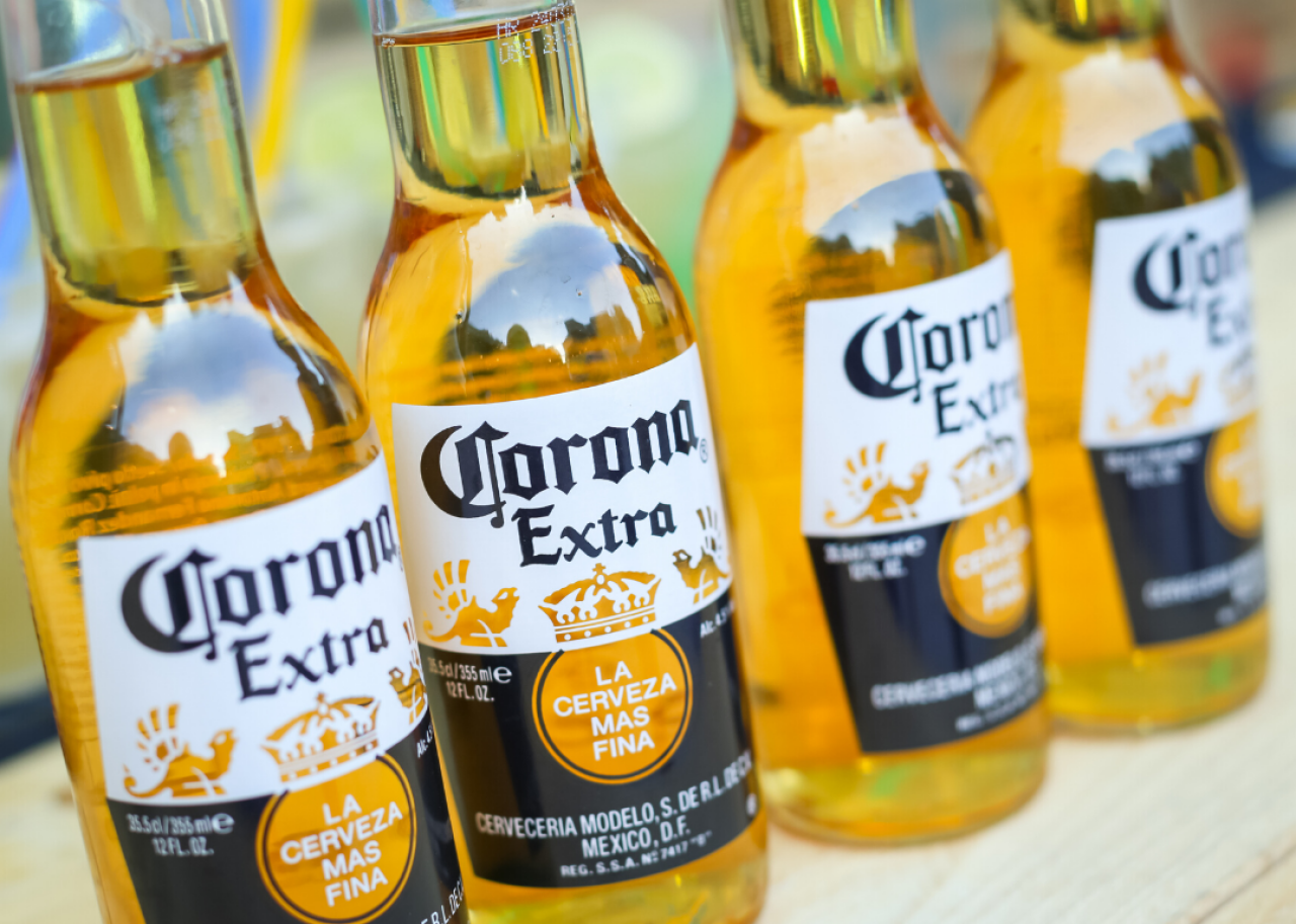 Four bottles of Corona Beer displayed on a counter.