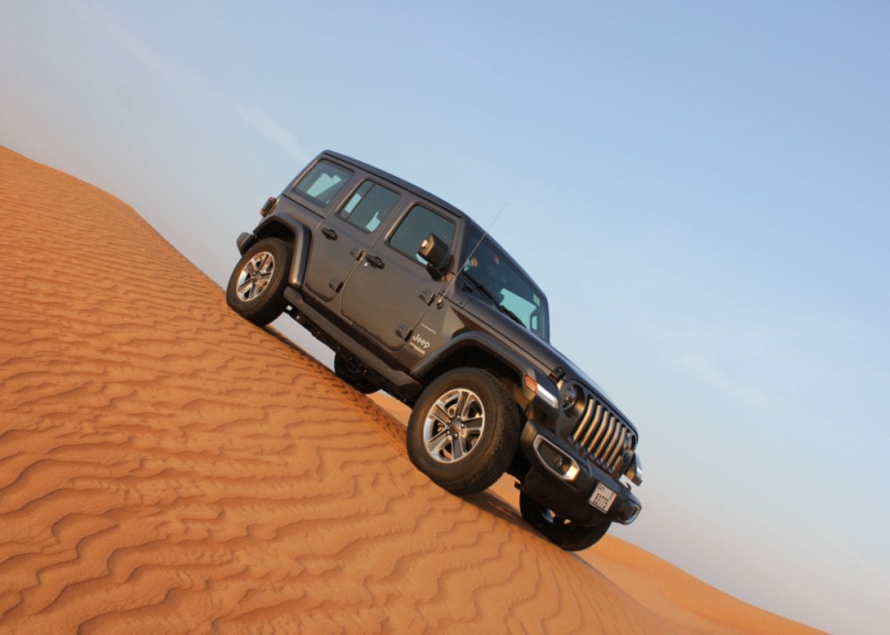 A gray Jeep Wrangler in the desert.