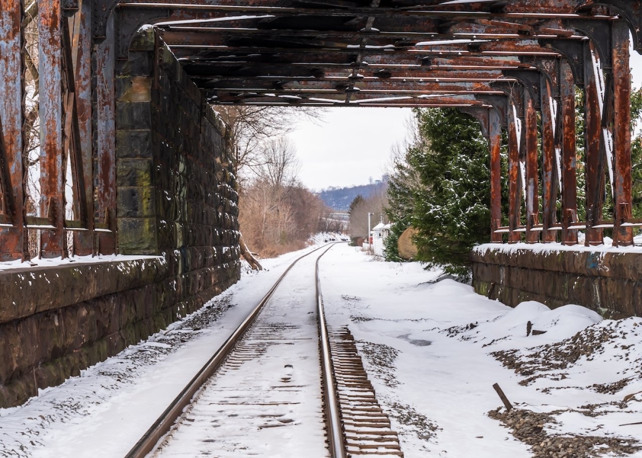 A train tunnel with snow covered train tracks on a winter day in Aspinwall, Pennsylvania.