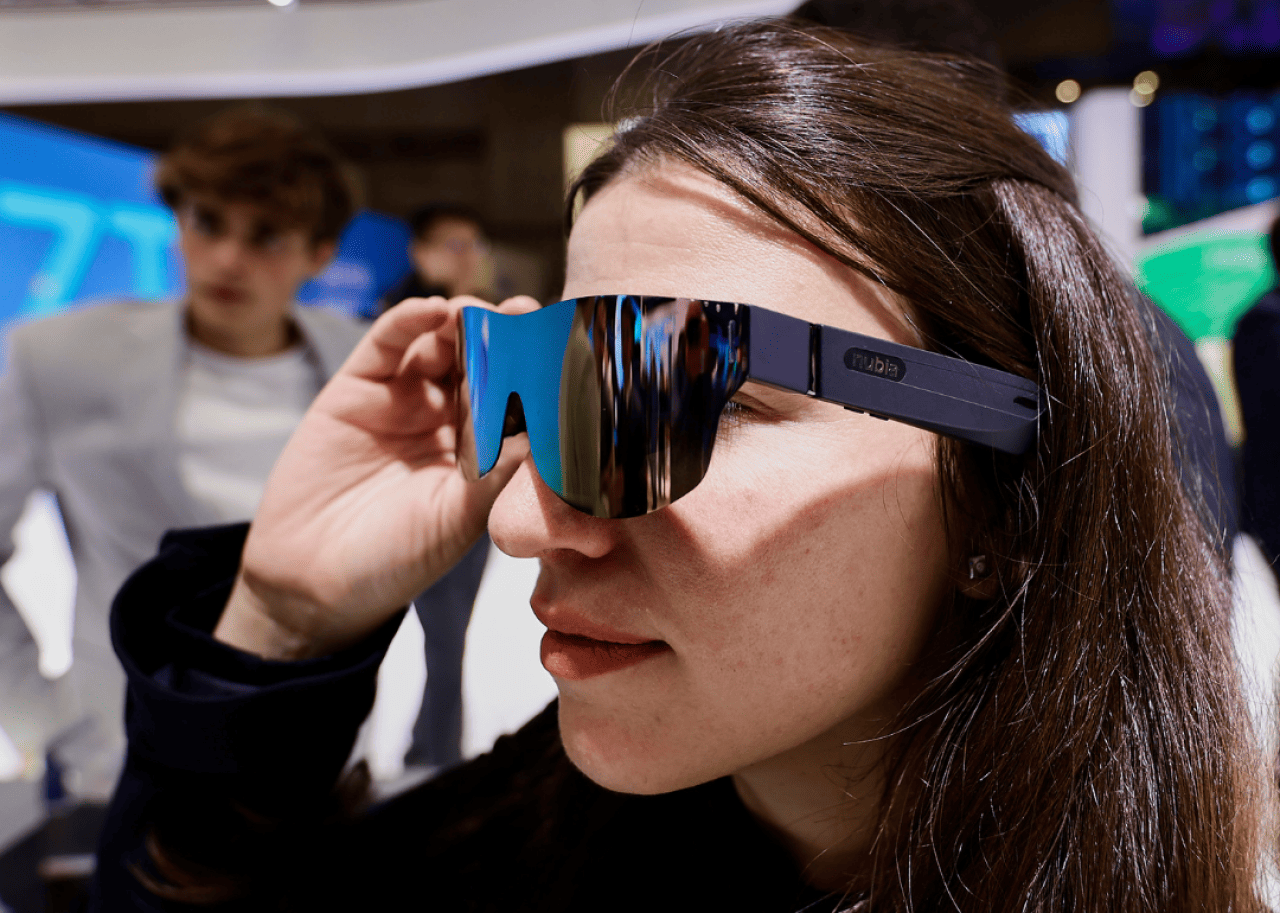 A woman trying on augmented reality glasses.