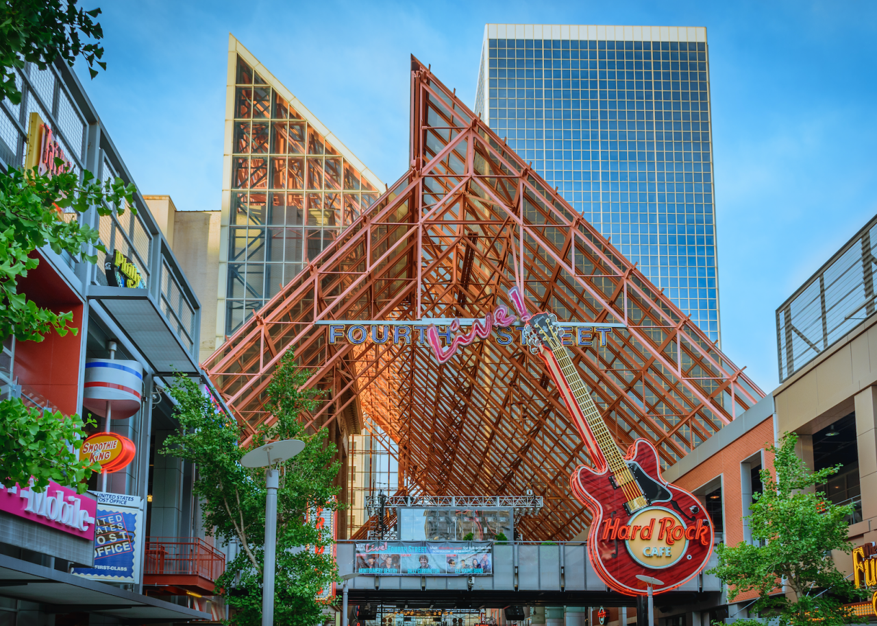 The exterior of a Hard Rock Cafe in a city.