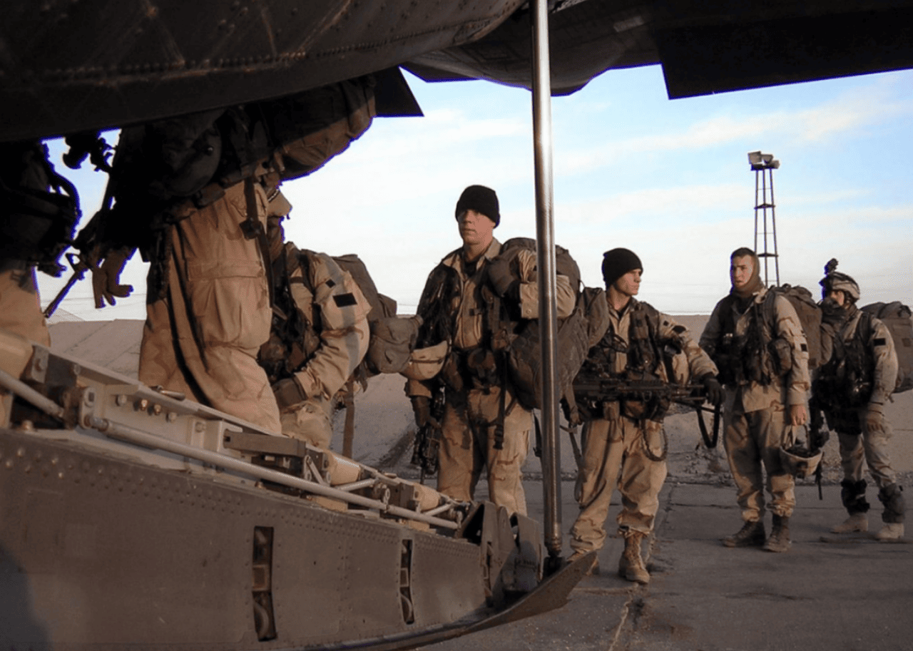Soldiers loading onto an airplane.