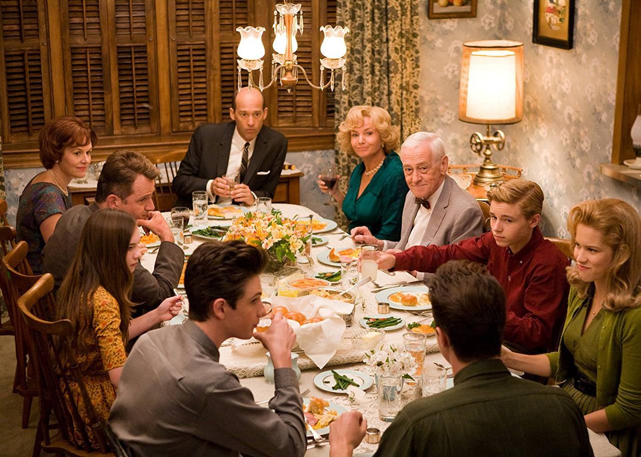 A family eats at a decorated table full of food.