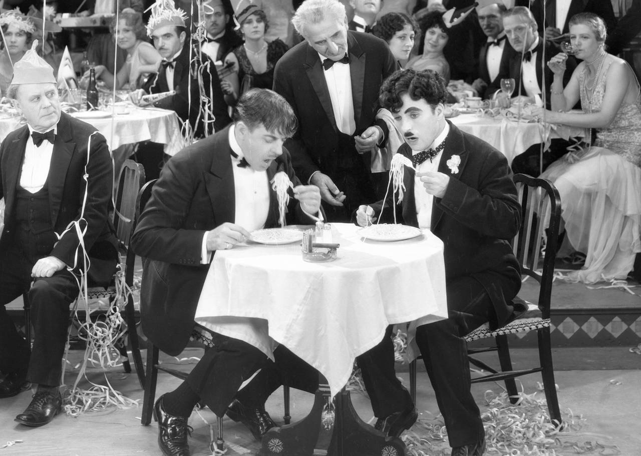 Men sit during an eating contest.