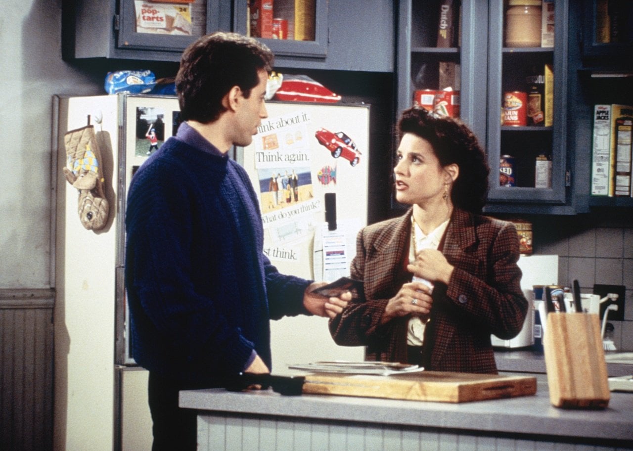 Jerry Seinfeld and Julia Louis-Dreyfus in the kitchen on an episode of Seinfeld.