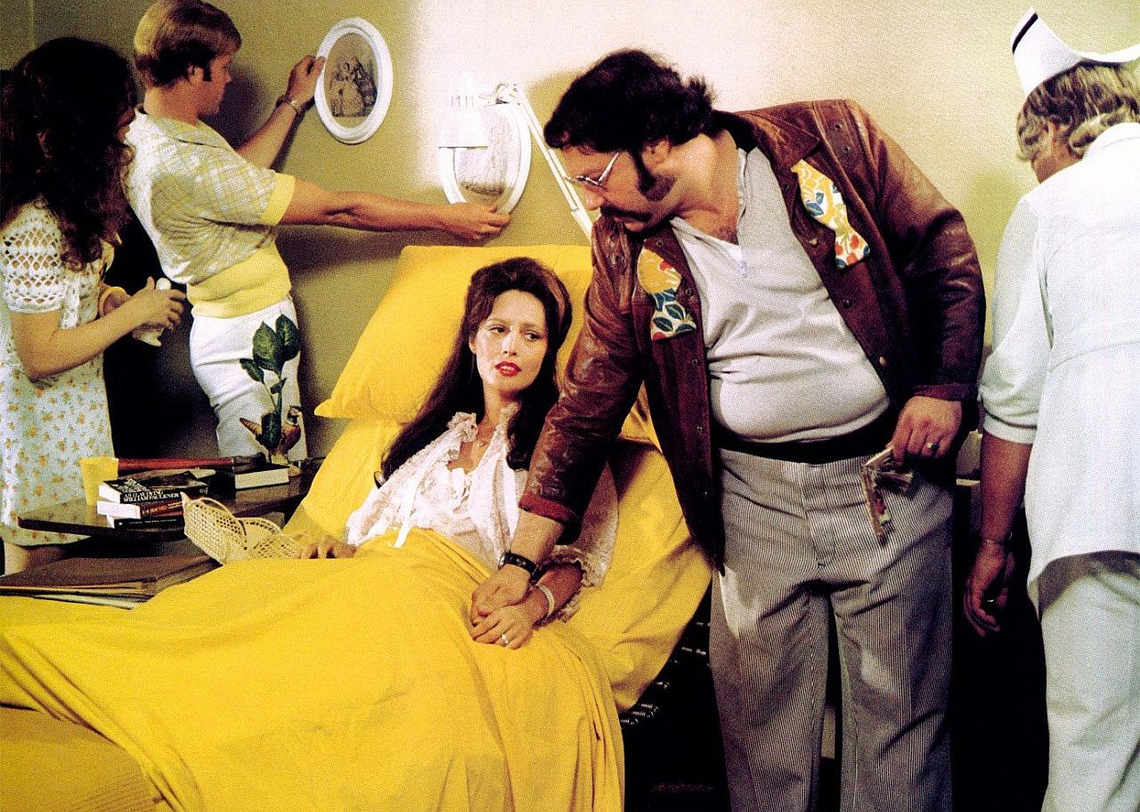 People decorate a woman's hospital room in all yellow.