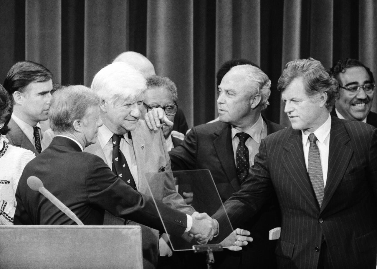 President Carter and Sen. Edward Kennedy finally shake hands as Democratic Convention chairman Thomas 