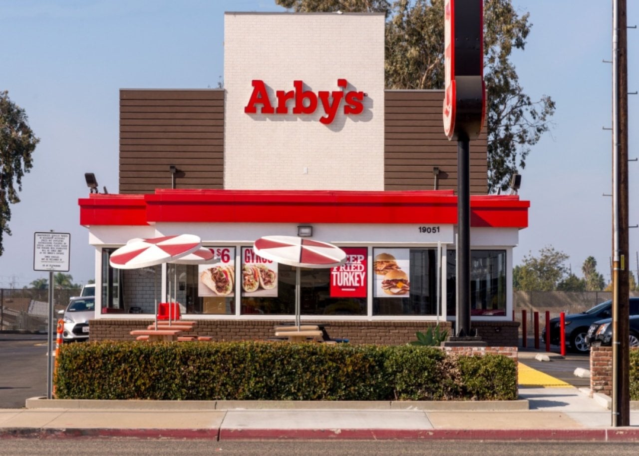 The red and white exterior of an Arby's restaurant.