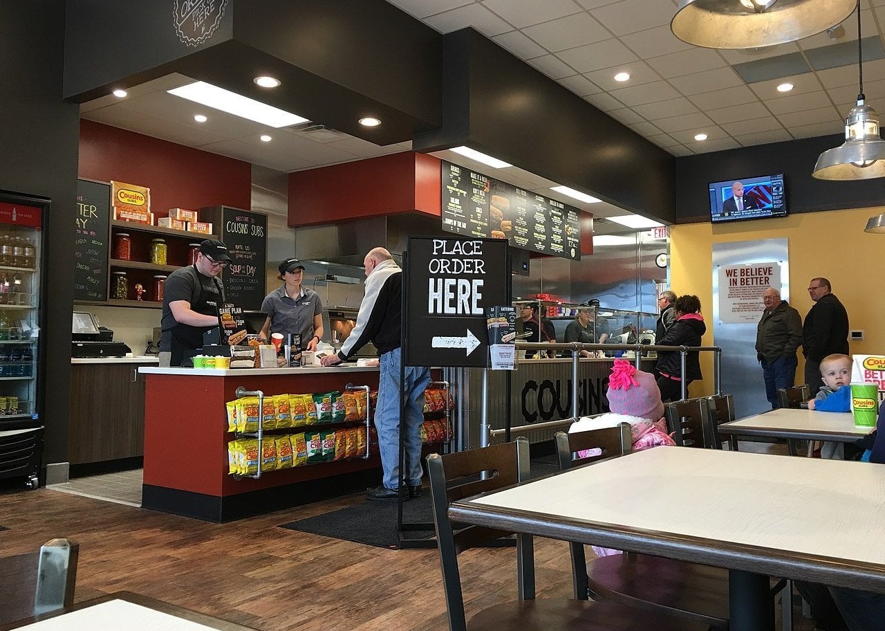 People in line ordering at a Cousins Subs location.