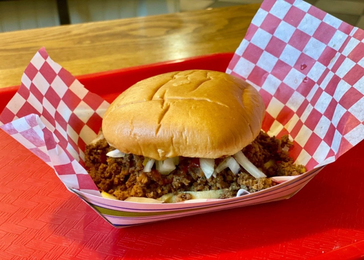 A seasoned ground beef loose meat sandwich on a bun.