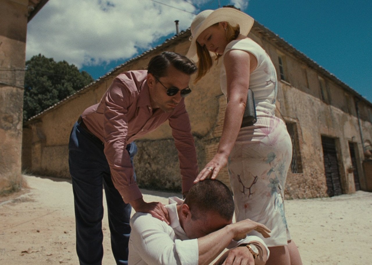 Kieran Culkin and Sarah Snook stand with their hands on Jeremy Strong, who is seated with his head in his lap.