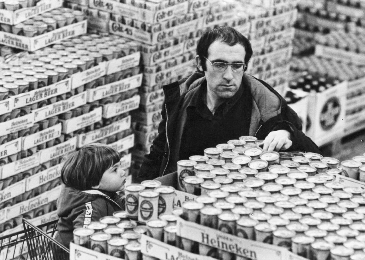 A man finds the Heineken beer display at a market.
