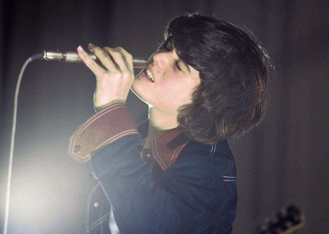 Donny Osmond singing into a microphone.