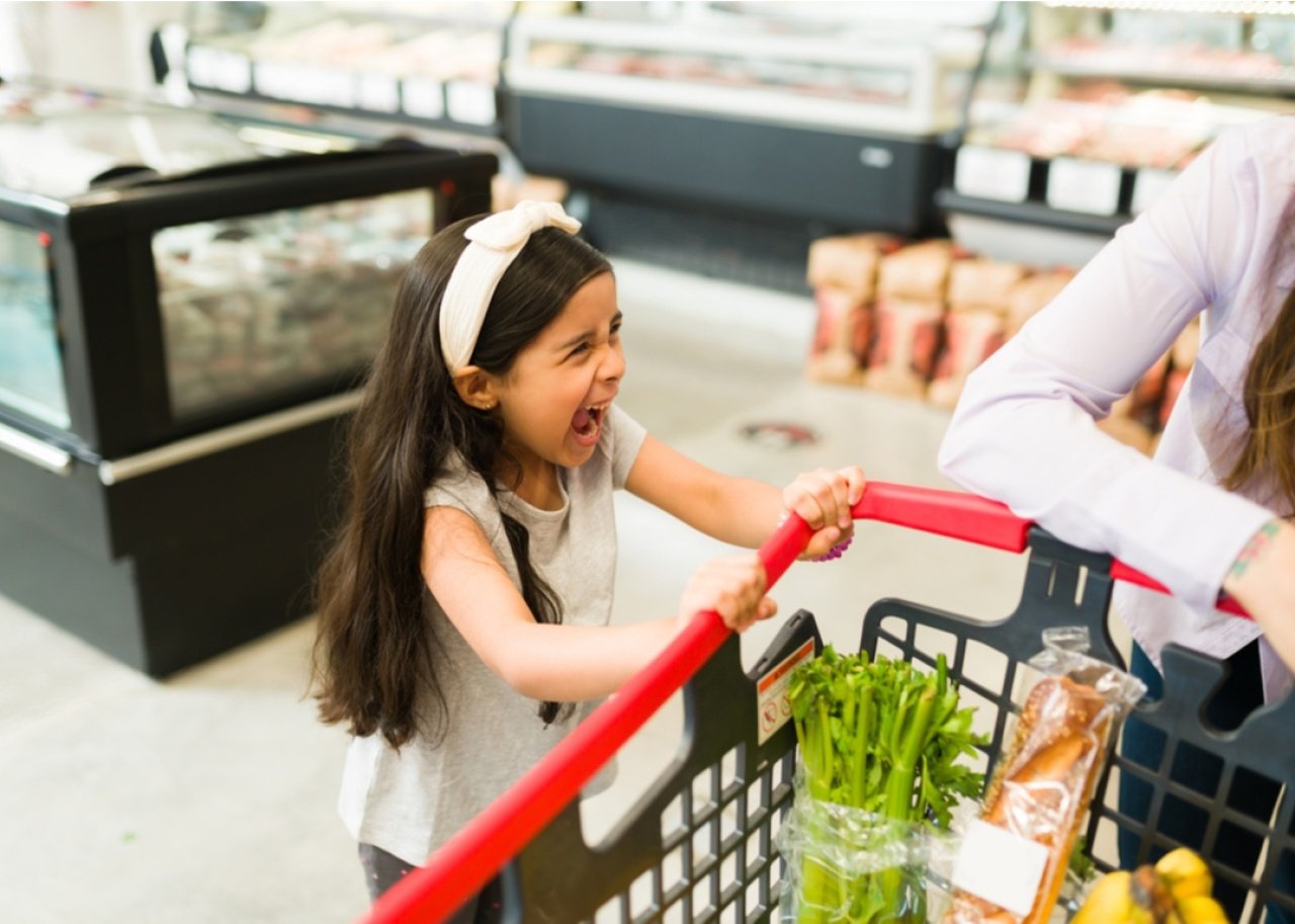 Girl throwing a tantrum in the grocery store.