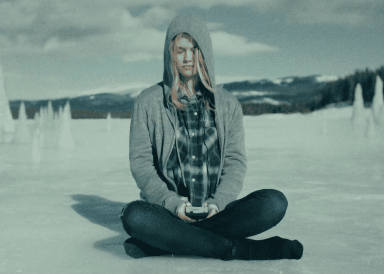 A girl sitting on the ice.