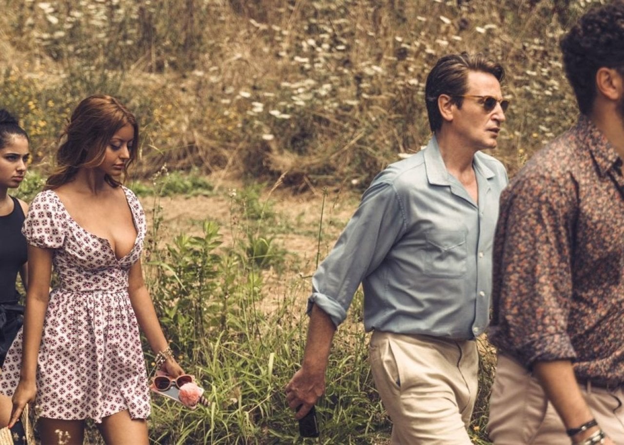 Two young girls following two men.