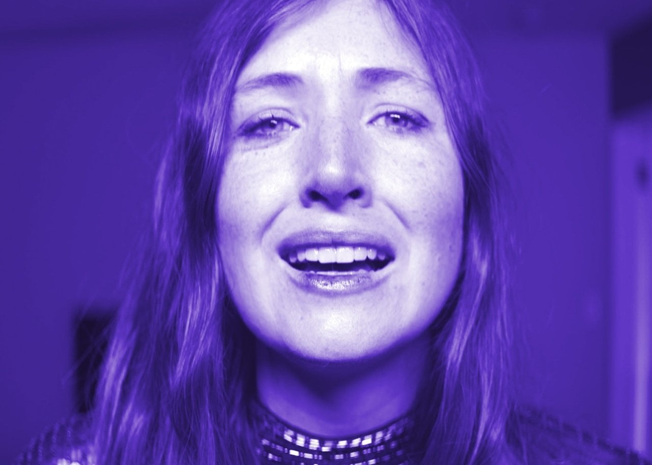 A scared woman in blue light.