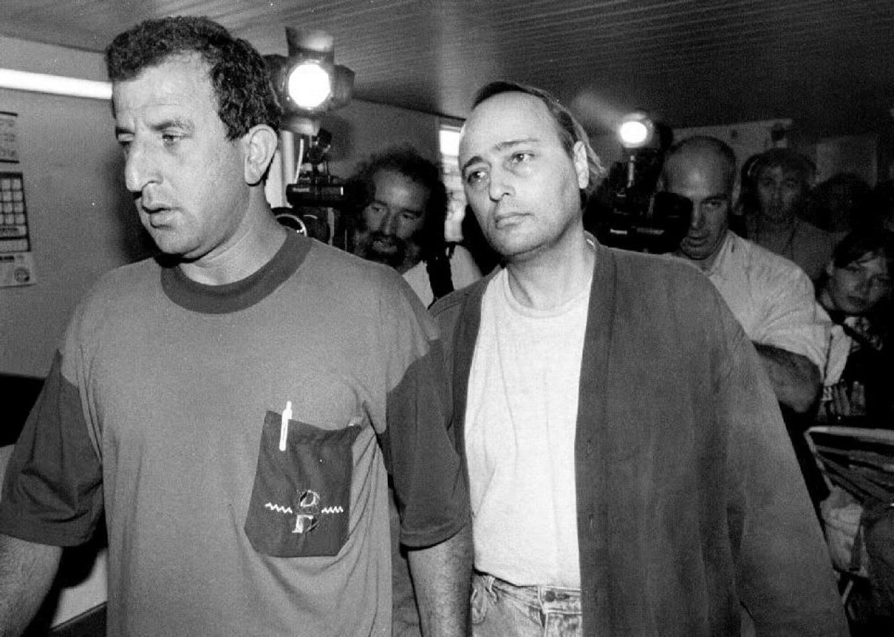 Eddie Antar is led by a police detective.