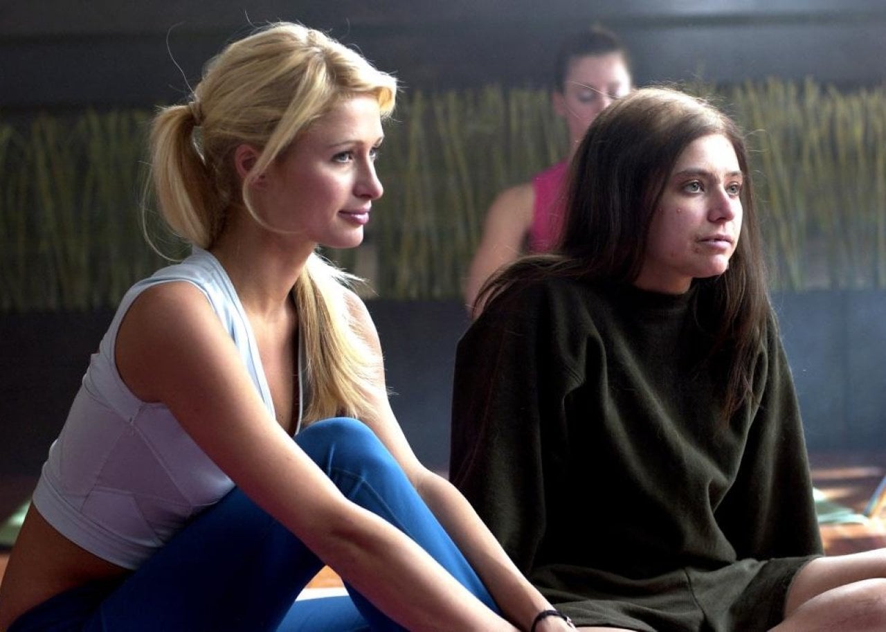 Paris Hilton sitting next to an ugly girl.